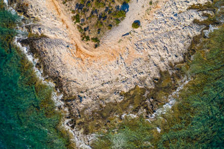 Adriatic coastline in Croatia, Dugi otok island. Rocky cape and sea surface, drone overhead view.の写真素材