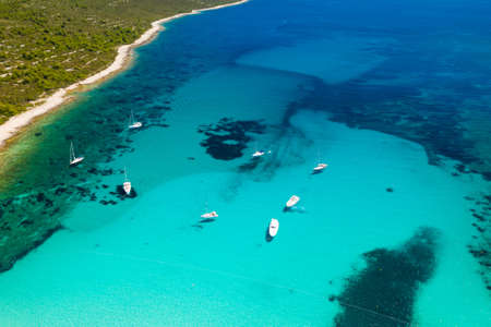 Amazing Adriatic sea in Croatia. Aerial view of azure turquoise lagoon on Sakarun beach on Dugi Otok island, yachts anchored blue sea, tourist paradise.の写真素材