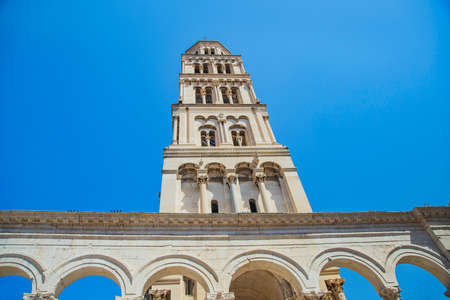 Croatia, tower of cathedral and stone arches in Roman emperor Diocletian palace in the city of Split. Tower on blue sky. UNESCO site. National heritage.のeditorial素材