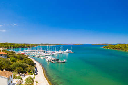 Marina in Veli Rat on Dugi Otok island on Adriatic sea coastline in Croatia, aerial view from drone,...