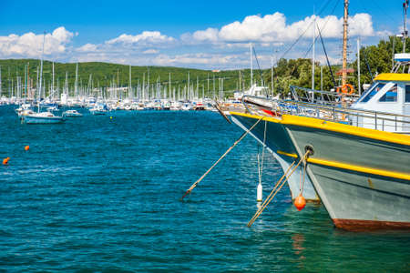 Waterfront and old ships in the harbor in town of Punat on the island of Krk, Adriatic coast, Croatiaの写真素材