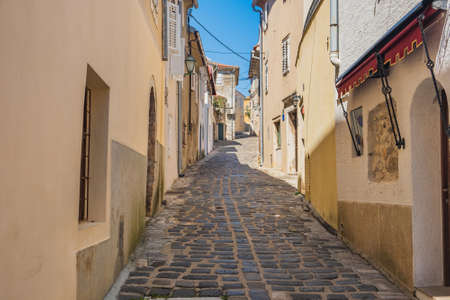 Narrow street and old houses in the old town of Krk on the island of Krk in Croatiaの写真素材