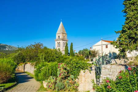 Beautiful ancient town of Osor on the island of Cres in Croatia, gardens and cathedral towerの写真素材