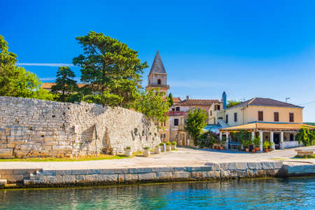 Fortress and cathedral tower in old town of Osor between islands Cres and Losinj, Croatia, seascape in foregroundの写真素材