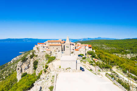 Amazing historical town of Lubenice on the high cliff, Cres island in Croatia, Adriatic sea in backgroundの写真素材