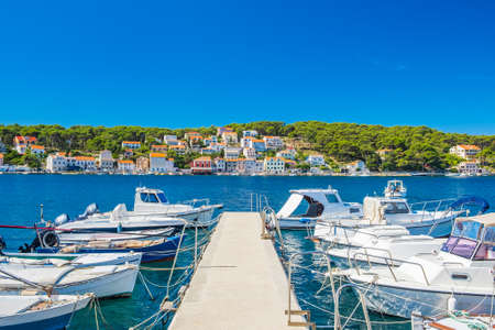 Town of Mali Losinj on the island of Losinj, Adriatic coast in Croatia, boats on docks and old houses in backgroundの写真素材