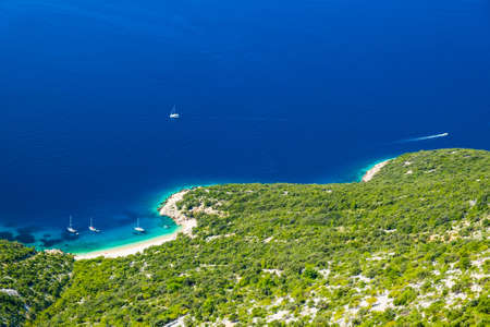 Croatia, amazing island of Cres on Adriatic coastline, aerial view of azure lagoon and beach under Lubenice townの写真素材