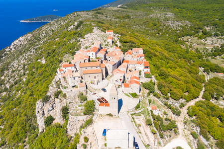 Amazing historical town of Lubenice on the high cliff, Cres island in Croatia, Adriatic sea in backgroundの写真素材