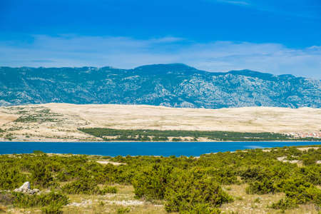 Landscape on the island of Pag in Croatia, Velebit mountain in backgroundの写真素材
