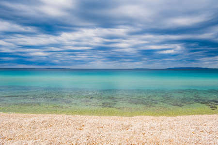 Croatia, island of Pag, Adriatic Sea shore and cloudy sky over horizonの写真素材