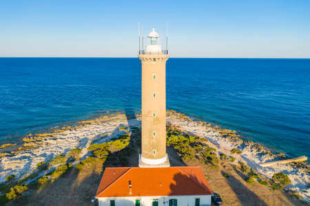 Pine forest and old lighthouse of Veli Rat on the island of Dugi Otok, Adriatic sea horizon in background, beautiful Croatiaの写真素材