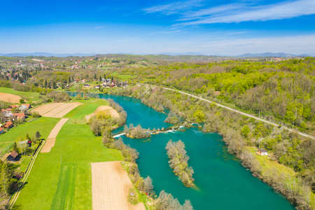 Panoramic view of countryside landscape, Mreznica river and Donji Zvecaj village from air, Croatiaの写真素材