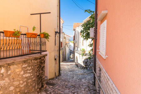 Old street in in historic town of Omisalj on Krk island in Croatiaの写真素材