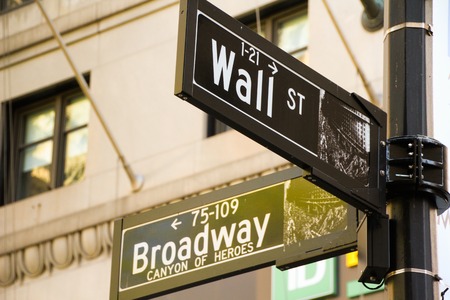 Street signs at the intersection of Wall St. and Broadway in Manhattan, New York