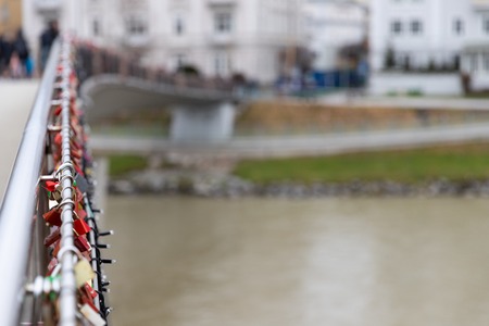 Bridge full of love locks (padlocks) and Christmas lights in Salzburg, Austriaの写真素材