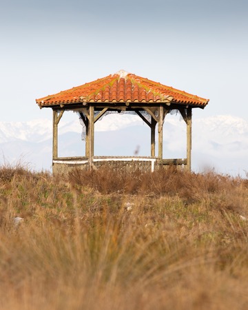 Wooden kiosk with view to the snowy mountains in Rodopi, Greeceの写真素材