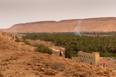 Oasis with palm trees and plantation next to a small town in Ziz Gorges, Morocco