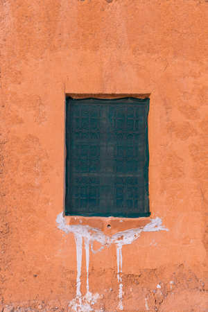 Covered window on an orange colored wall in Morocco countryside (Tinghir area)の写真素材