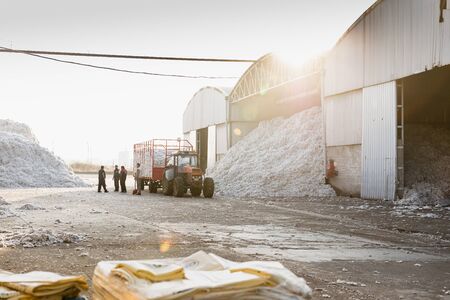 Cotton farmer waiting for the tractor trolley to get unloaded in the ginning mill in Greeceの写真素材