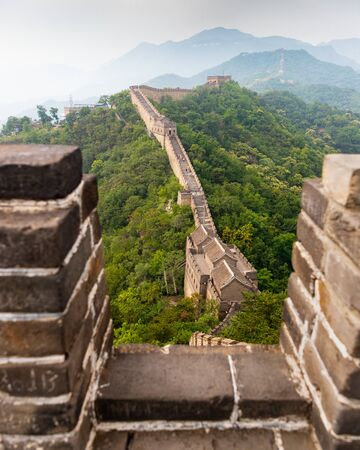 Great Wall of China and surrounding mountains on a misty, summer dayの写真素材