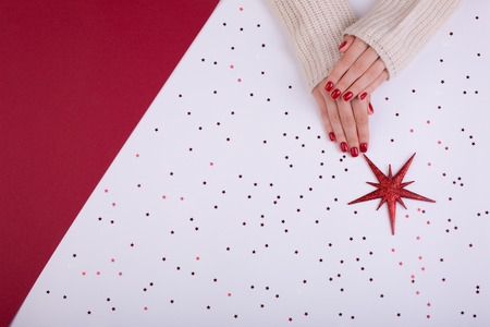 Red festive female manicure. Flat lay style.の写真素材