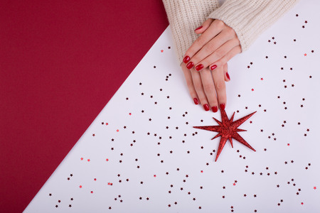 Red festive female manicure. Flat lay style.の写真素材