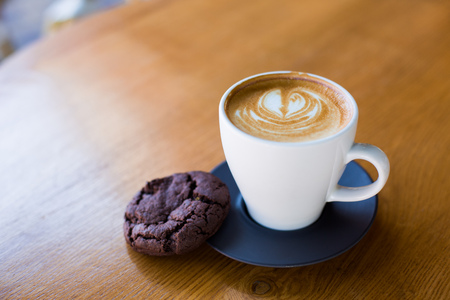 Cup of coffee served with chocolate cookie.の写真素材