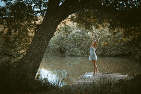 young sexy woman on the bridge by the riverの写真素材
