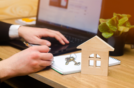 real estate buying an apartment. Real estate agent putting signing contract, sitting at the computer. moving home or renting propertyの写真素材