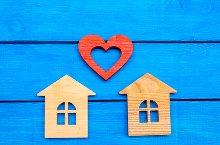 Wooden houses and heart on a blue backgroundの写真素材