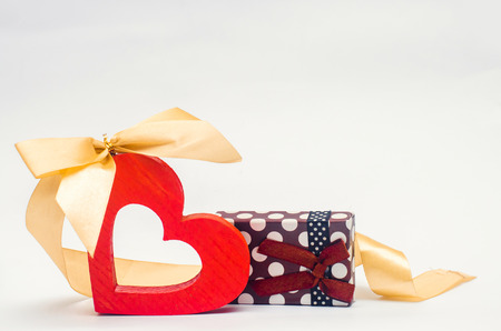 wooden heart with bow and gift on white background.Valentine's Day

の写真素材