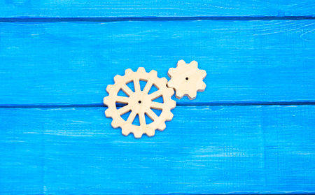 wooden gears , cogwheel, on a blue background, technology, mechanismの写真素材