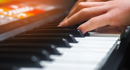 Close-up of a music performer's hand playing the piano, man's hand, classical music, keyboard,...