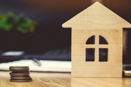 coins and model of the house. real estate buying an apartmentの写真素材