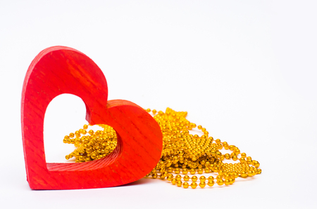 wooden red heart  and string of beads on a white background. Valentine's Day

の写真素材