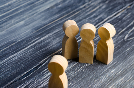 Three people meet one. Three people are aggressively attuned to one. People conduct an interview and a meeting. The concept of attack, threats, encounters, education. Businessmen stand in a group of three.の写真素材