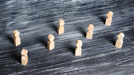 Crowd. Pedestrians and passers-by. Wooden figures of people stand apart from each other in solitude.の写真素材