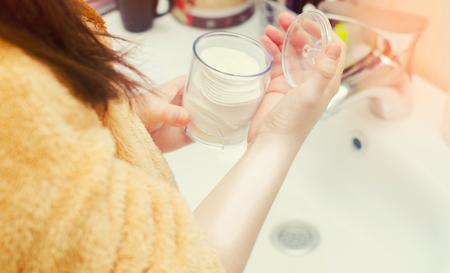 wadded disks in hands. make-up removal, cosmetics. の写真素材
