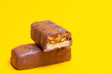 chocolate bars on a yellow background. sweets, candyの写真素材