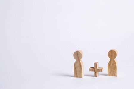 Two people with a plus in between. Wooden figures of persons. Friends, relatives, lovers. Social mathematics. Partner. Man plus man on white background. A new person, Improvisationの写真素材