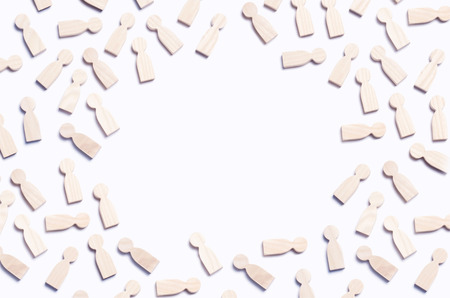 Wooden figures of people on a white background. The concept of society, collective, company, family, neighbors. A crowd of people at a meeting. Place for text. Workers, employees, citizens.の写真素材