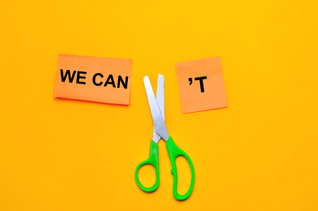 we can self motivation - cutting the letter t of the written word we can't so it says we can, goal achievement, potential, overcomingの写真素材