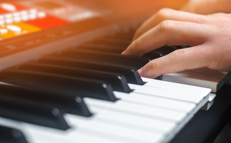 Close-up of a music performer's hand playing the piano, man's hand, classical music, keyboard, synthesizer, pianistの写真素材