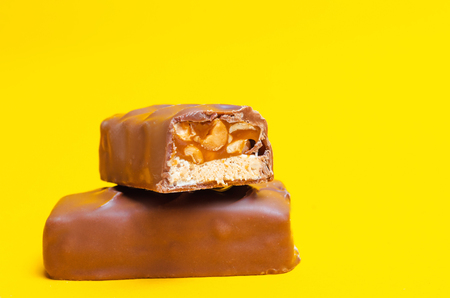chocolate bars on a yellow background. sweets, candyの写真素材