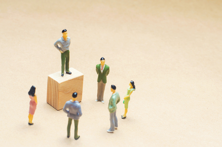 a man stands and conducts agitation, auction, public sales, investment attraction, webinar, scammers and financial pyramid, a crowd of people listening to the speaker, space for text, isolated backgroundの写真素材