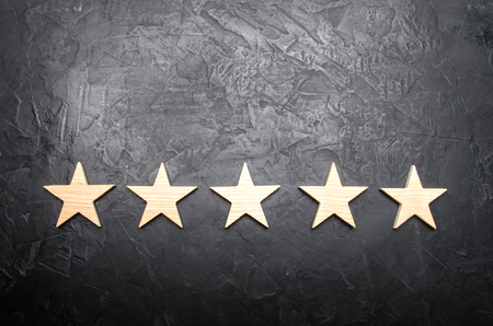 five stars on a dark background. The concept of rating and evaluation.の写真素材
