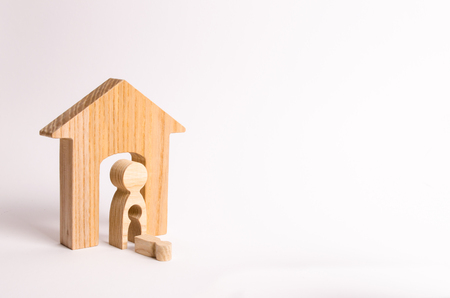 A wooden figure of a woman and a fallen child from the emptiness of her body. The concept of pregnancy and premature birth, miscarriage and Stresa. Accident. Injured child. Unhappy mother.の写真素材
