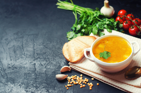fresh liquid pea soup on chicken broth. bean soup with parsley. healthy breakfast. black concrete background. place for text. copyspace. selective focus.の写真素材