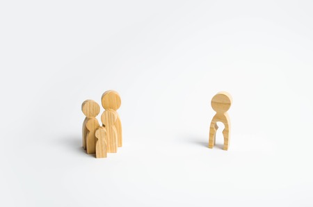 Wooden figurines of people in the shape of a family and a man with the emptiness of a child inside the body on a white background. The concept of family planning, treatment of infertility.の写真素材