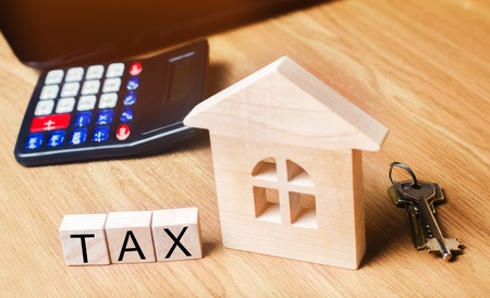 Concept of property taxes, purchase and sale of property and house. inscription "tax". Declaration of the income of a physical person. Income to the budget. Payment of taxes to the state.の写真素材